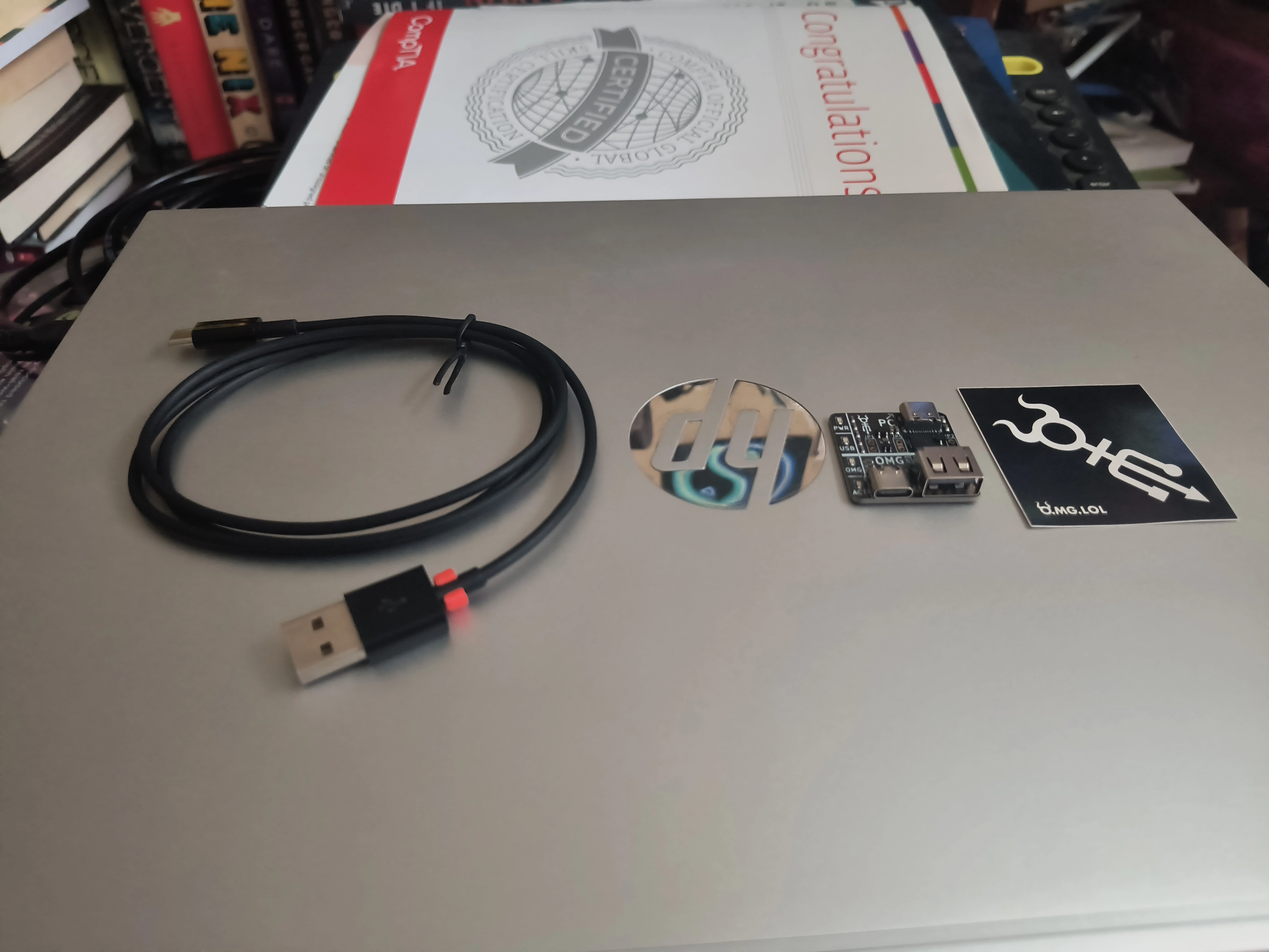 OMG Cable unboxed, alongside the programmer board and stickers